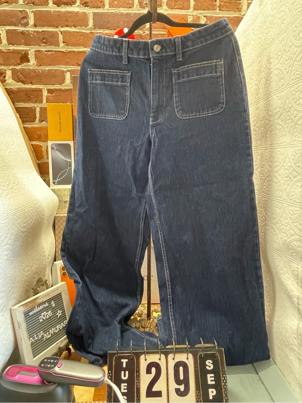 Free assembly dark-wash wide-leg jeans feature distinctive front patch pockets